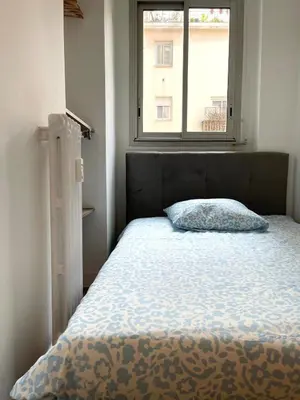a bed with a pillow in a bedroom with a window at Super studio Carré d'Or-2 people-Nice in Nice