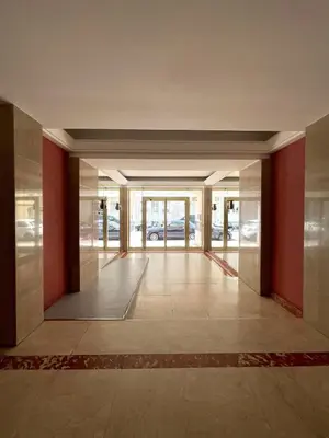 an empty lobby with red walls and glass doors at Super studio Carré d'Or-2 people-Nice in Nice