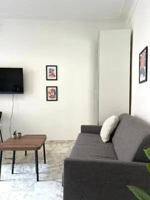 a living room with a couch and a table at Super studio Carré d'Or-2 people-Nice in Nice