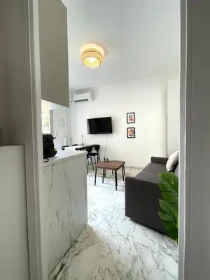 a white living room with a couch and a table at Super studio Carré d'Or-2 people-Nice in Nice