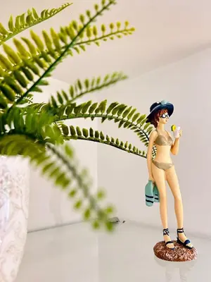 a figurine of a woman in a bikini holding a ball at Azure Horizons Seaside Escape in Beaulieu-sur-Mer