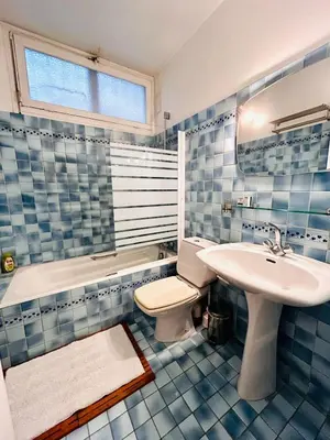 a bathroom with a sink and a toilet and a tub at Azure Horizons Seaside Escape in Beaulieu-sur-Mer