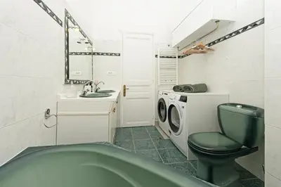 a bathroom with a green toilet and a washing machine at Sumptuous Art Deco Apartment - 6 People in Nice