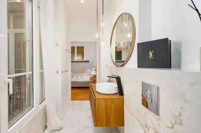 a bathroom with a sink and a mirror at Sumptuous Art Deco Apartment - 6 People in Nice