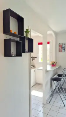 a kitchen with a counter and a table in a room at Appartement 2P, balcon, parking proche mer in Nice