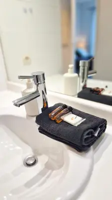 a bathroom sink with a black towel and a faucet at Appartement 2P, balcon, parking proche mer in Nice