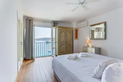 a bedroom with a bed with a view of the ocean at EDEN VIEW AP4469 by Riviera Holiday Homes in Villefranche-sur-Mer