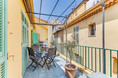 a balcony with a table and chairs on it at EDEN VIEW AP4469 by Riviera Holiday Homes in Villefranche-sur-Mer