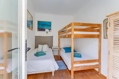 a bedroom with two bunk beds and a ladder at EDEN VIEW AP4469 by Riviera Holiday Homes in Villefranche-sur-Mer