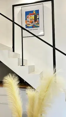 a picture of feathers on a staircase with a picture at Appartement LOFT in Nice