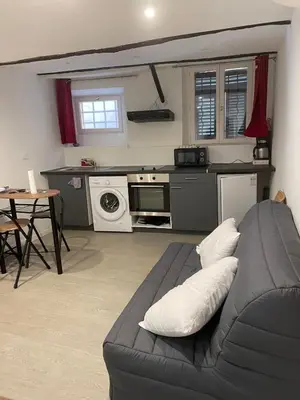 a living room with a couch and a kitchen at Studio Vieux Nice in Nice