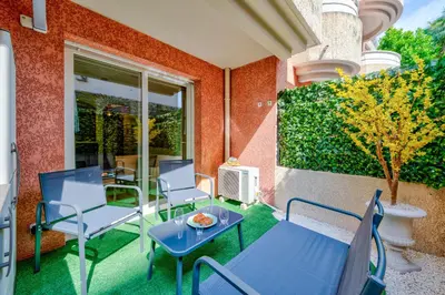 a patio with chairs and a table and a heater at Studio Jardin Parking et Clim in Nice
