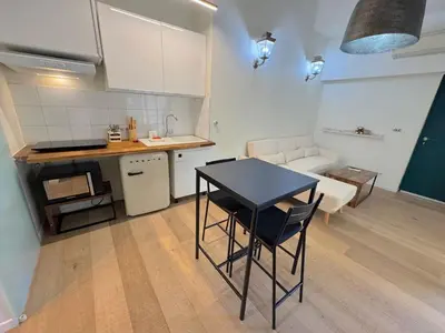 a small kitchen with a table and a table and chairs at ⁂ Charmant Mezzanine Central - Clim Wifi Famille in Nice