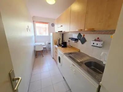 a small kitchen with a sink and a refrigerator at Renoir SeaSide Apartment in Nice