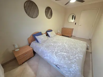 a bedroom with a bed and a ceiling fan at Renoir SeaSide Apartment in Nice