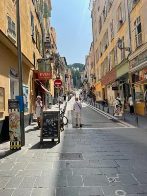 a city street with people walking down the street at Recently renovated apartment in quiet area in heart of Old Nice in Nice