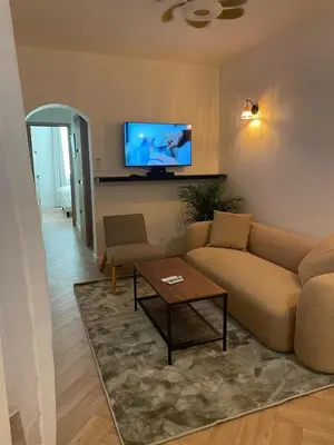 a living room with a couch and a tv on the wall at Recently renovated apartment in quiet area in heart of Old Nice in Nice