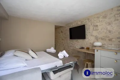 a bedroom with a bed with a tv on the wall at Studio in Villefranche in Villefranche-sur-Mer