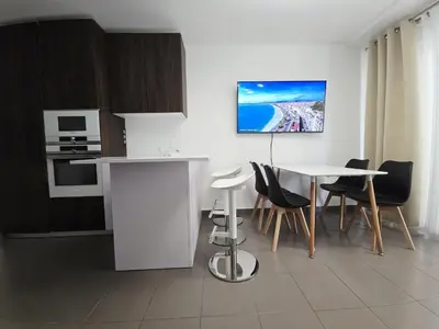 a kitchen with a table and a table and chairs at Nice Riquier 8 in Nice
