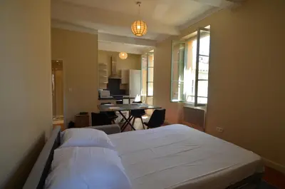 a bedroom with two beds and a table in a room at STE REPARATE - Cosy 2 pieces vue cathedrale in Nice