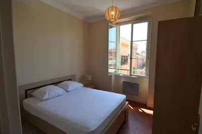 a bedroom with a white bed and a window at STE REPARATE - Cosy 2 pieces vue cathedrale in Nice