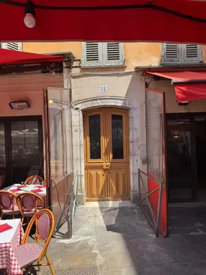 a wooden door of a building with tables and chairs at STE REPARATE - Cosy 2 pieces vue cathedrale in Nice