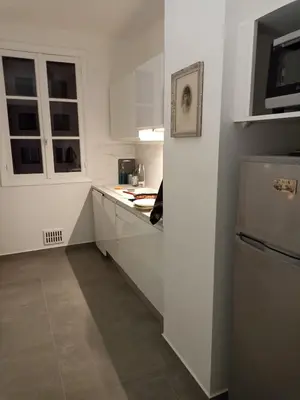 four different pictures of a kitchen with white cabinets at Port de Nice-charmant appartement bucolique ! vue port in Nice