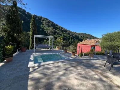a swimming pool on the patio of a house at Domaine Baccia Donna Proche Nice, Climatisation, Jacuzzi chauffé, Pétanque & Parking gratuit in La Trinité