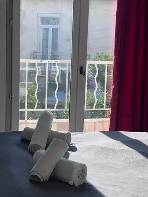two towels on a bed in front of a window at Studio à 5min de la plage in Nice