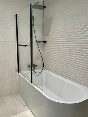 a glass shower in a bathroom with a tub at Azure blue in Nice