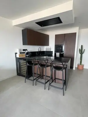 a kitchen with a black table and stools at Azure blue in Nice