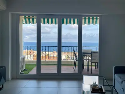 a living room with a window view of the ocean at Azure blue in Nice