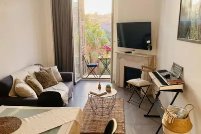 a living room with a couch and a table at Charming central apartment for 6 in Nice