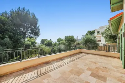 a balcony of a house with trees in the background at Central Luxurious Property in Antibes