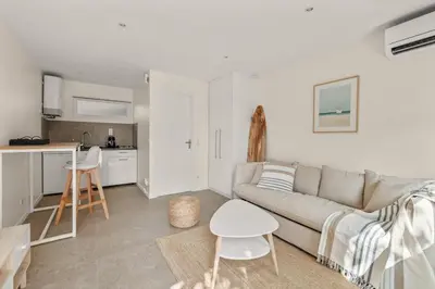 a living room with a couch and a table at Central Luxurious Property in Antibes