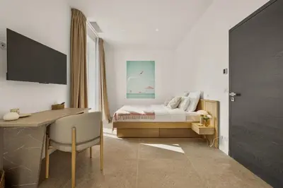a bedroom with a bed and a desk and a deskablish at Central Luxurious Property in Antibes