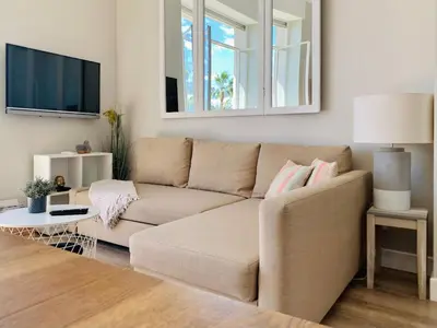 a living room with a couch and a tv at Stunning flat with sea view & garden on Promenade dA in Nice