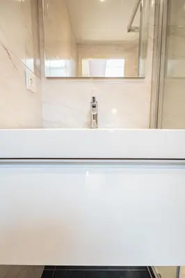 a bathroom with a sink and a mirror at Le Toit d'Azur in Nice