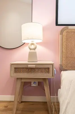 a lamp on a table next to a bed at Le Toit d'Azur in Nice