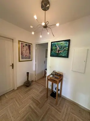a living room with a table and a ceiling at Spacieux appartement, Jardin, vue mer, calme in Nice