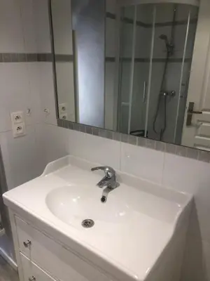 a bathroom sink with a large mirror above it at Villefranche in Villefranche-sur-Mer
