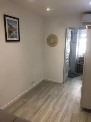 a living room with white walls and wooden floors at Villefranche in Villefranche-sur-Mer