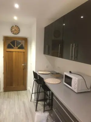 a kitchen with a counter with a microwave and stools at Villefranche in Villefranche-sur-Mer