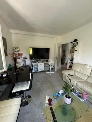 a living room with a couch and a table at Appartement Nice promenade des anglais in Nice
