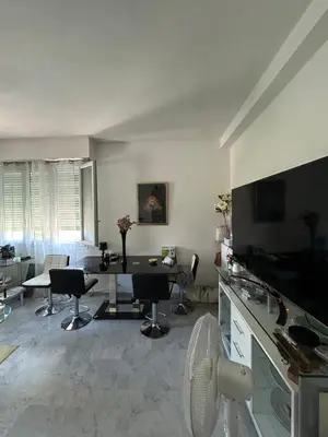 a living room with a table and chairs at Appartement Nice promenade des anglais in Nice