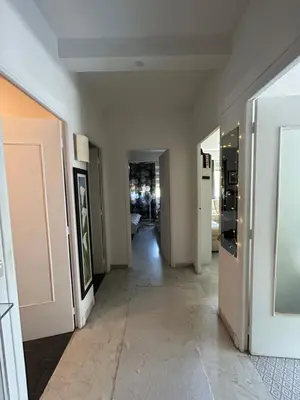 a hallway with white walls and a hallway with a hallway at Appartement Nice promenade des anglais in Nice