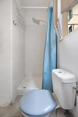 a bathroom with a white toilet and a shower at Nice et confortable 2 pièces cozy in Nice