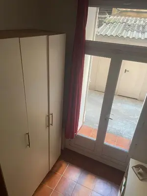a small room with a window and a door at Studio Carré d 'Or - 5 minutes de la mer in Nice
