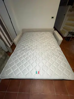a bed in a room with a white mattress at Studio Carré d 'Or - 5 minutes de la mer in Nice