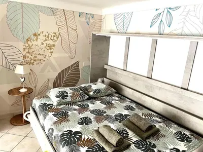 a bedroom with a bed with pillows on it at Cozy apartement near the beach with with Aircon in Nice